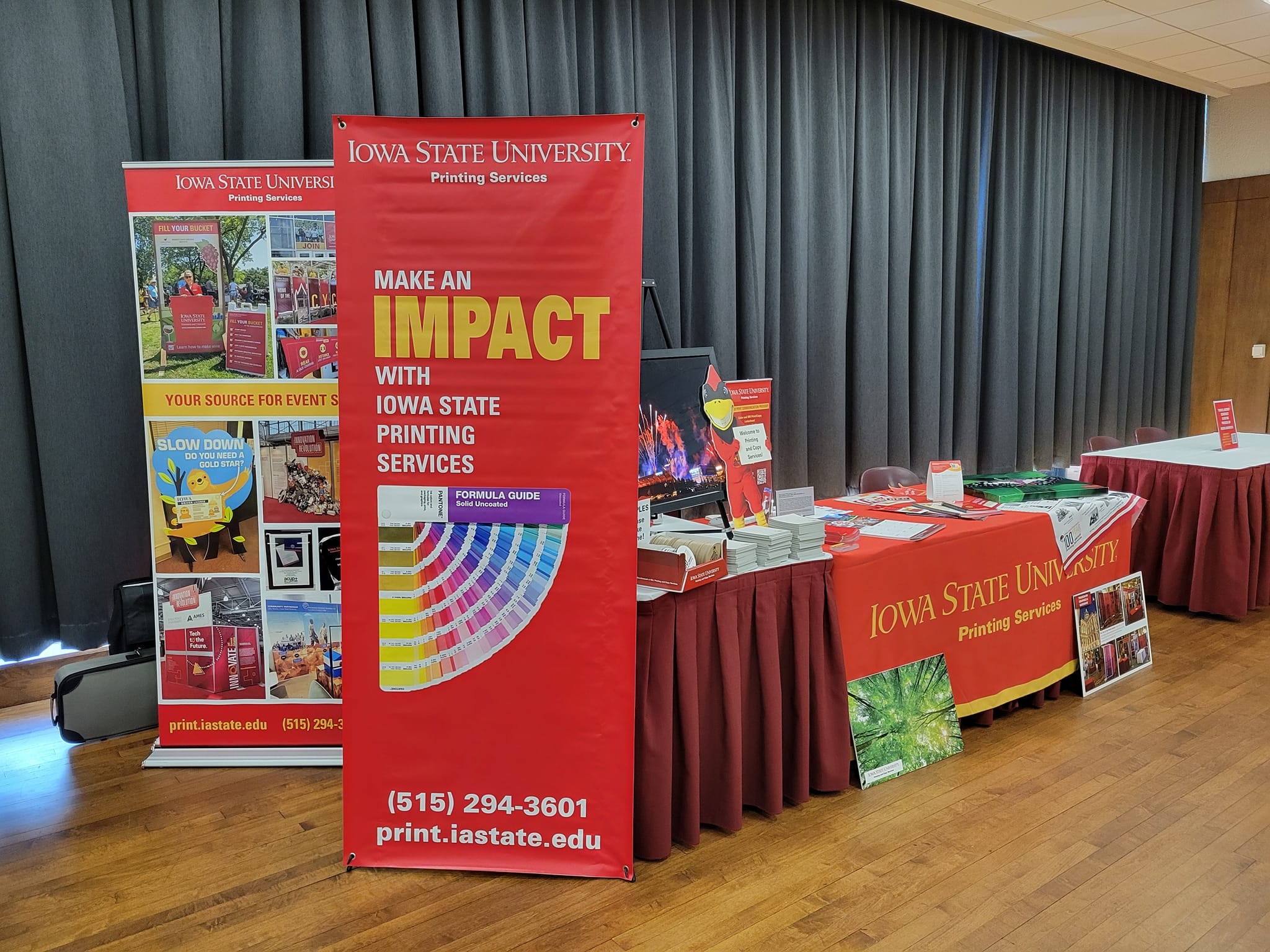A table with two banner stands that shows different products that we offer.